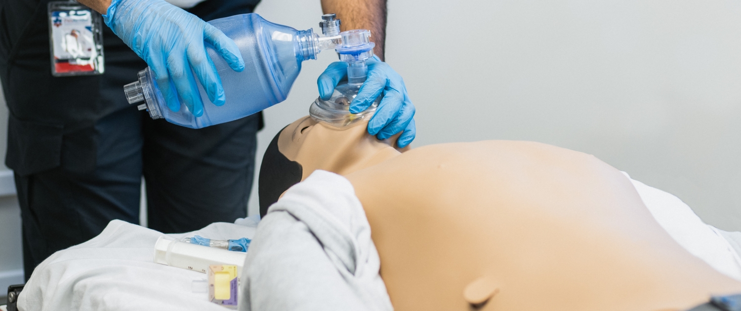 Student delivers respirations while performing CPR