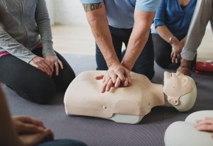 Instructor demonstrating CPR on a manikin